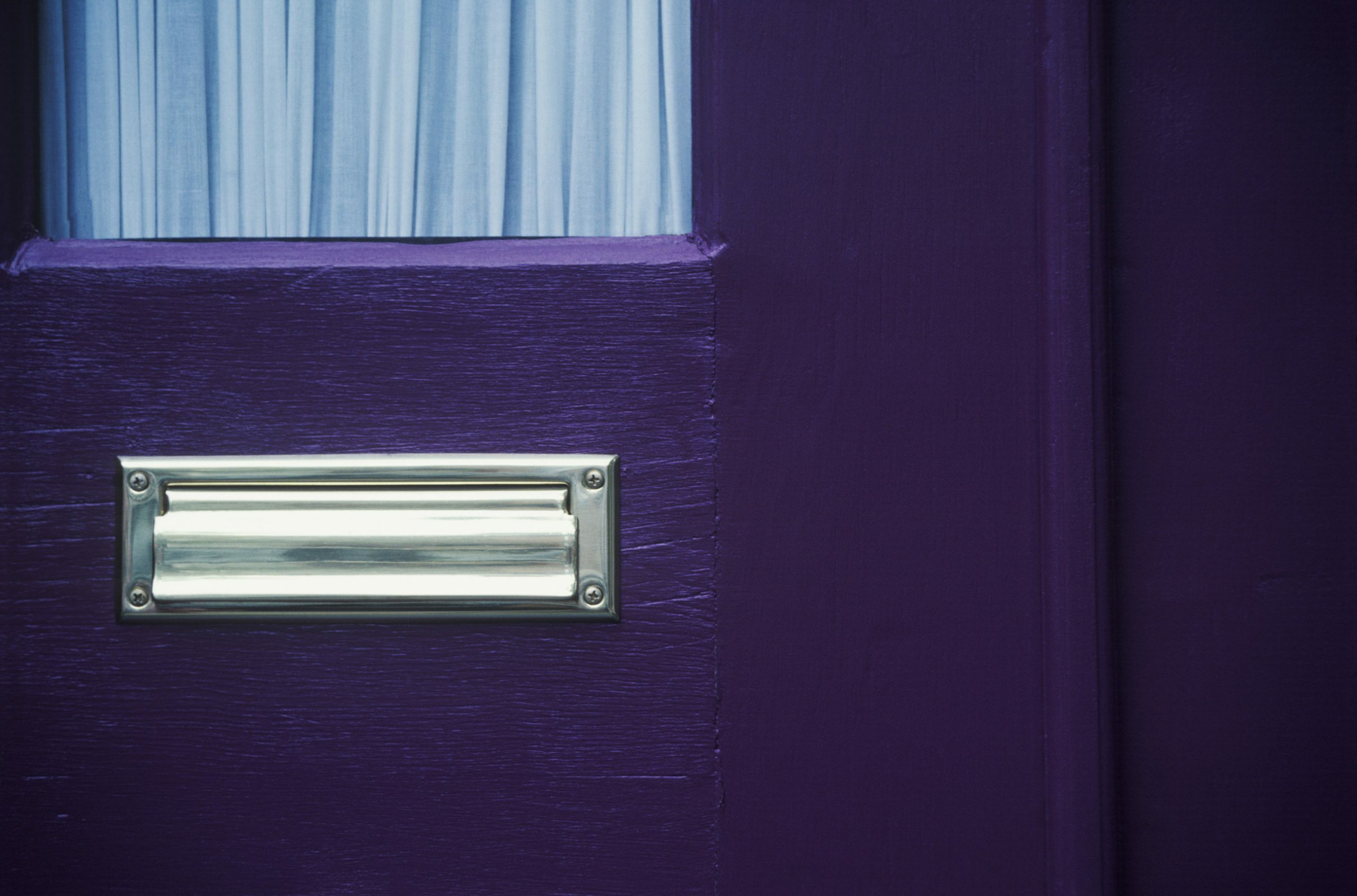 A purple door with mail slot to illustrate What Are HOAs And How Do They Benefit Your Community blog post.